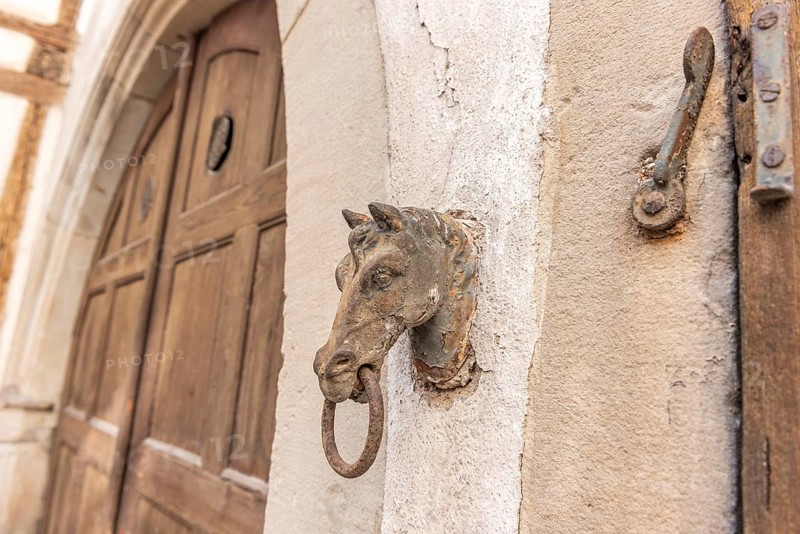Old rusty horse's head with a ring for tying horses in a backyard. Colmar, Haut-Rhin, Collectivite europeenne d'Alsace, Grand Est, France, Europe