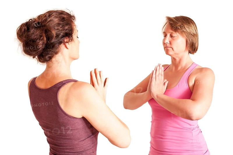 An image of some people doing yoga exercises
