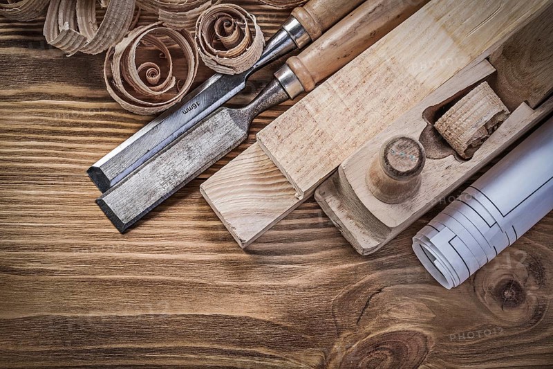 Blueprint shaving plane flat chisels wooden bricks shavings on wood board