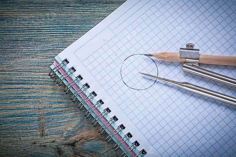 Vintage drawing compass pencil checked copybook on wood board construction concept