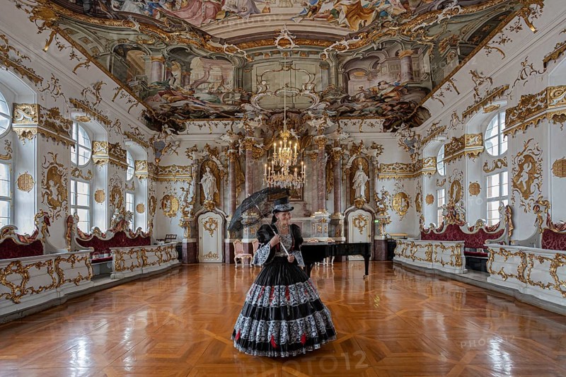 A woman in a black dress stands in a magnificent room with frescoed ceilings, staged photo shoot, Donau-Ries district, Bavaria, Germany, Europe