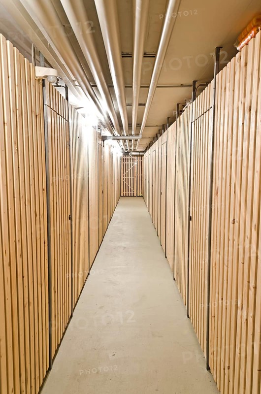 Aisle in a cellar with wooden storage units
