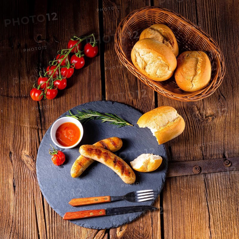 Rustic bratwurst with ketchup and fresh rolls