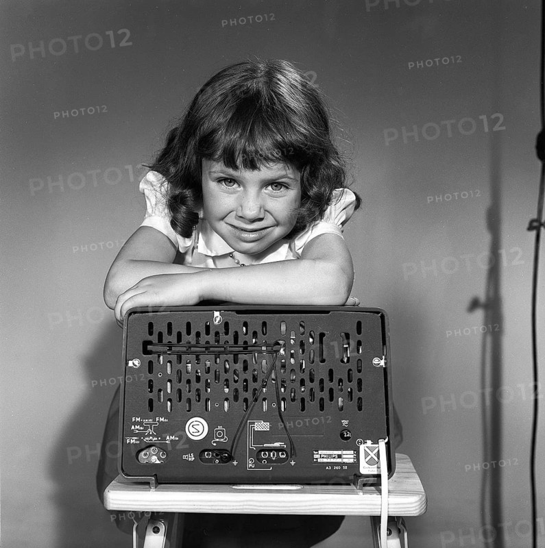 In the 1950s. A girl with a Philips radio set with the backside of the radio visible where the sockets for external antennas are placed. Sweden 1959. Kristoffersson ref CG70-12