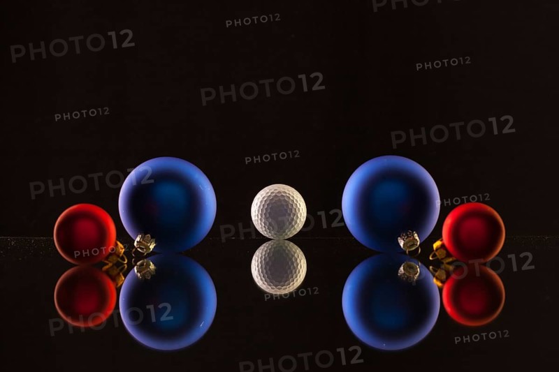 Golf ball and Christmas decoration on the glass table