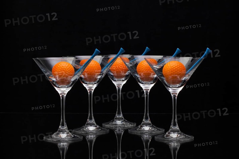 Five glasses of champagne with golf balls