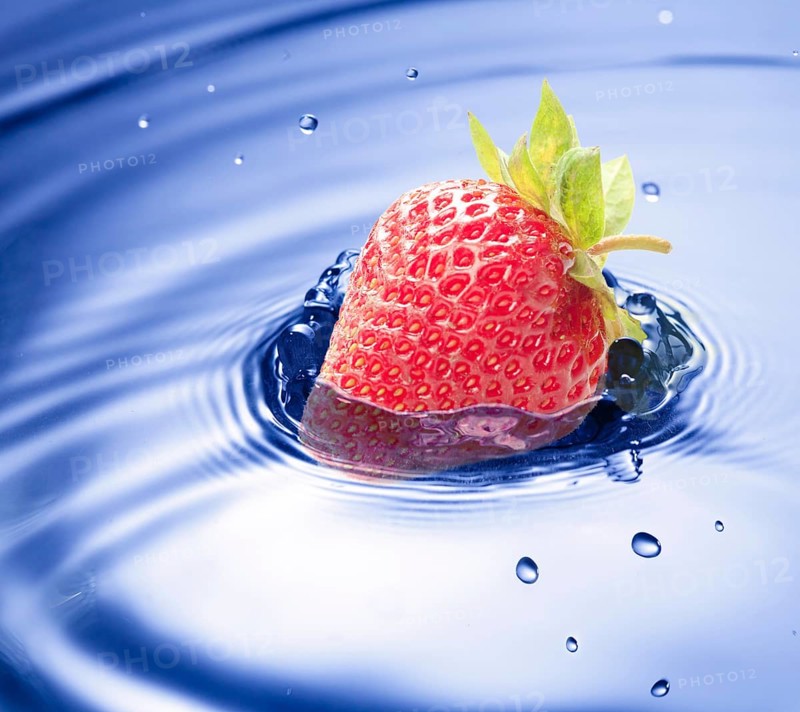 Blue water drop closeup with strawberry incide