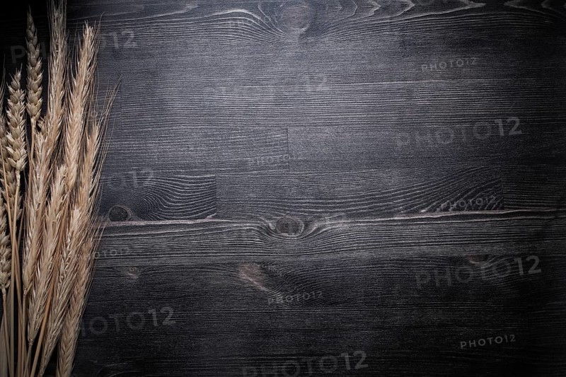 Wheat rye ears on wooden board food and drink concept