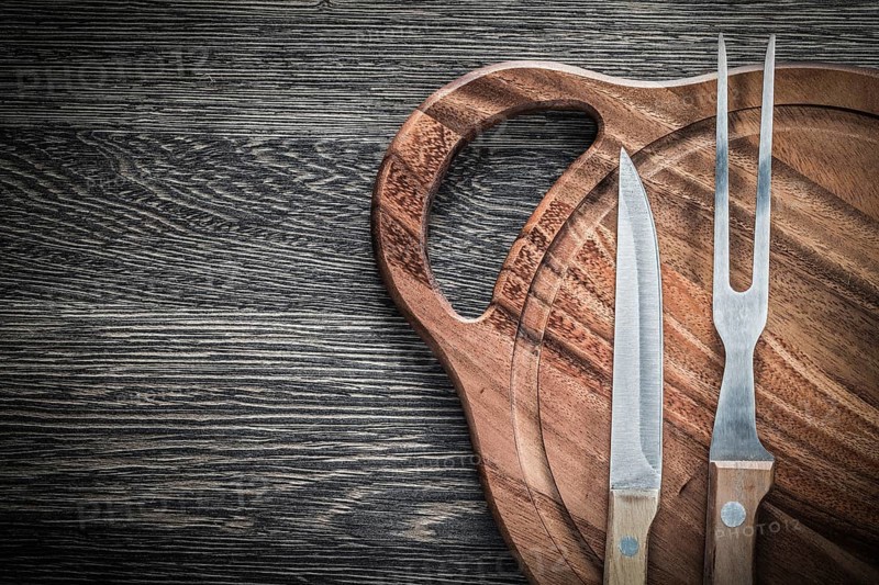 Meat fork knife chopping board on vintage wooden background