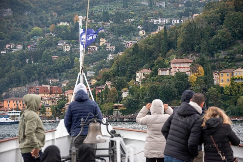 VARENNA, ITALY, OCTOBER 05, 2023, Tourists waiting for the ferry to dock at the harbor of Varenna, lake Como