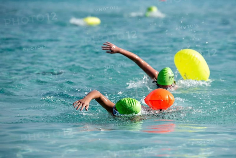 Athletes swimming free style in the sea during race competition. Aquathlon Swimmer in the ocean