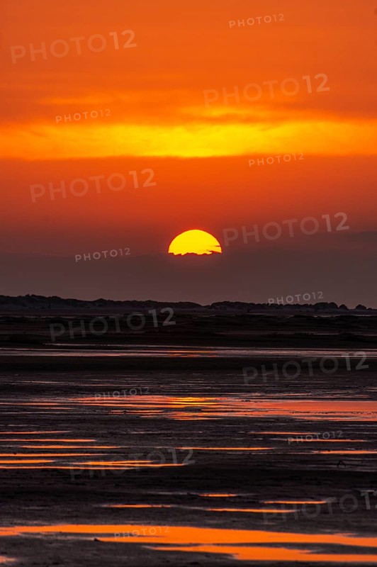 Beautiful golden coloured sunset at the seaside on the Isle Borkum
