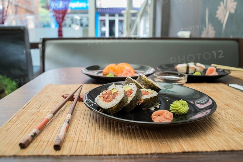 Sushi in sushi bar. Table and ration sushi