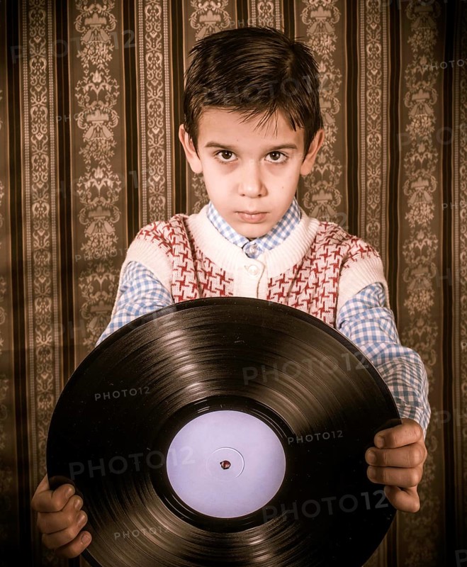 Child hold lp. Vontage clothes