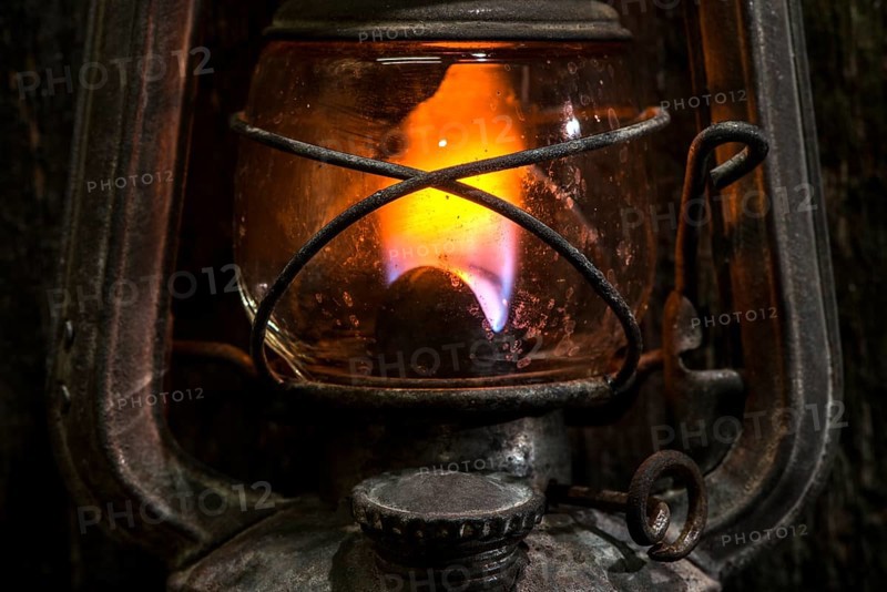 Old gas lantern on wood at darkness