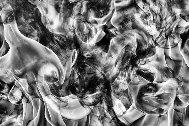 Abstract black smoke natural black smoke and white huge flame of strong fire. Dangerous firestorm abstract texture. Motion blur from fire, high temperature from flames. Dramatic black and white image