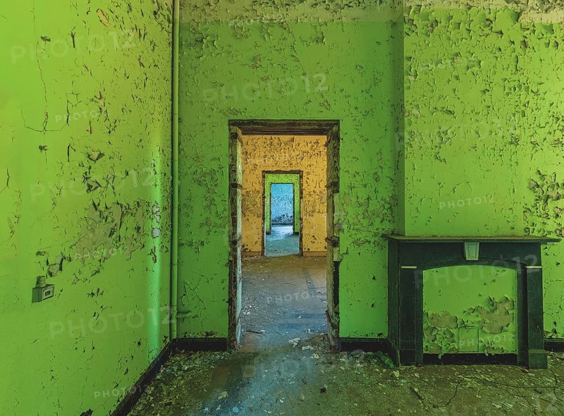 Dilapidated room with bright green wall colour and old fireplace, Prison H11, Lost Place, Verviers, Province of Liège, Belgium, Europe
