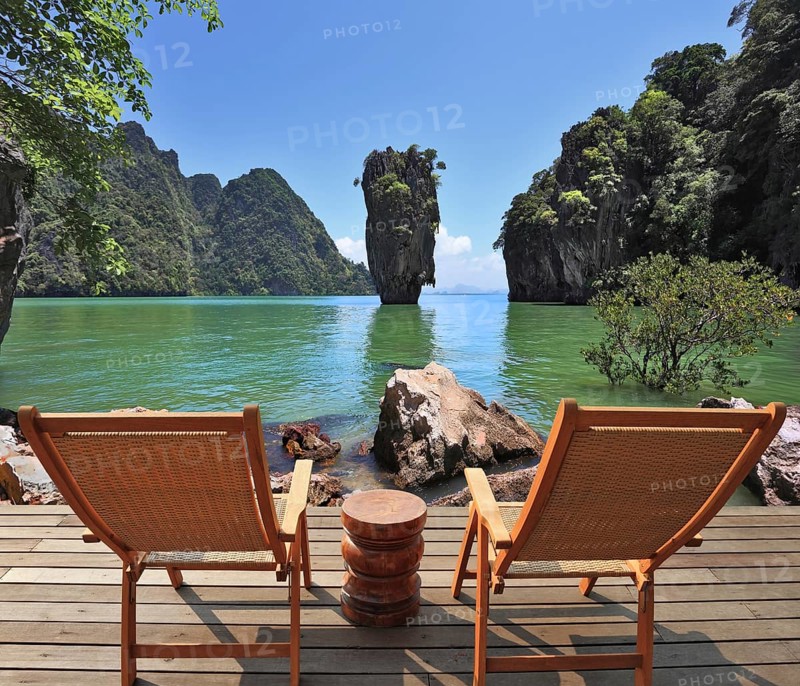 The most beautiful landscape in the world. The island in the form of a green vase in the sea gulf with clear emerald water. Two wooden chairs - on a wooden platform. The comfortable place to enjoy the beauty of the landscape