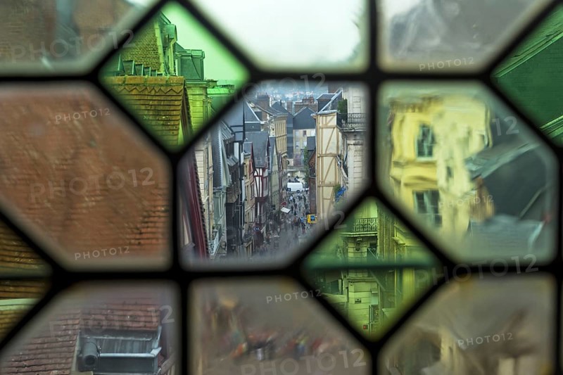 Rouen, France, August 30, 2018: View of the city street through the old window on the clock tower (Gros-Horloge) . Rouen, Normandy, France, Europe