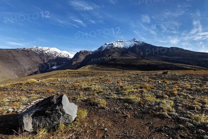 Panoramic volcanic landscape of Kamchatka Region: autumn view of Kozelsky Volcano on background of blue sky. Avachinsky-Koryaksky Group of Volcanoes, Kamchatka Peninsula, Russian Far East, Eurasia