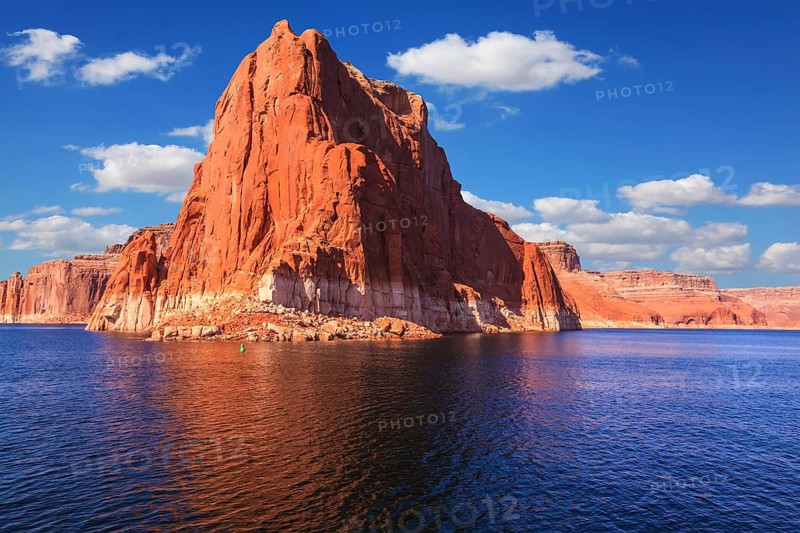 Lake Powell is surrounded by magnificent sandstone hills. Scenic huge artificial water basin of the Colorado River, USA. Walk on the boat at sunset