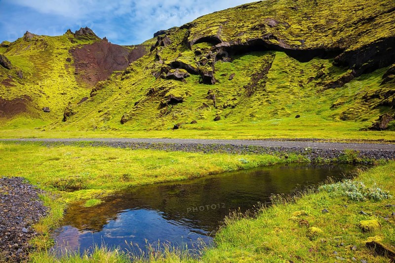 Picturesque basalt hills overgrown green grass and moss. On bottom of canyon many streams flow. Canyon Pakgil in Iceland