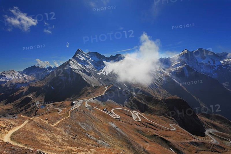 Famous picturesque views of the road in Austrian Alps - Grossglocknershtrasse. Ideal highway built high in the mountains. The highest mountain peaks covered with fresh snow