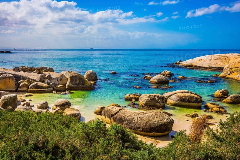 Huge boulders on the beach of the Atlantic Ocean. Boulders Penguin Colony in the Table Mountain National Park, South Africa. The concept of ecotourism