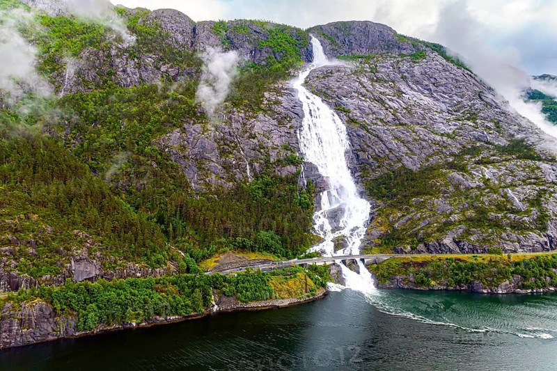 Langfossen is a magnificent cascading waterfal on the Vaule River. Passes through the highway. Western Norway. Filmed with a drone