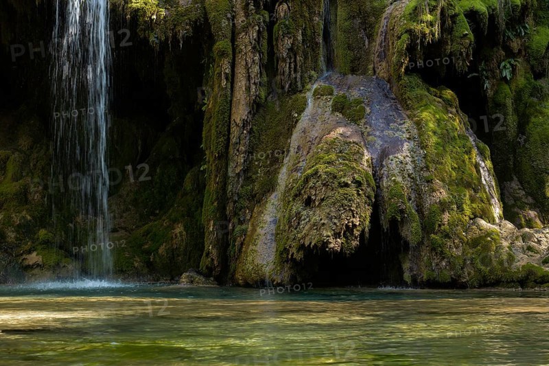 The tufa waterfall near Arbois. Crystal clear waterfall, powerful waterfall