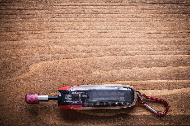 Replaceable screwdriver bits in toolbox on wooden board construction concept
