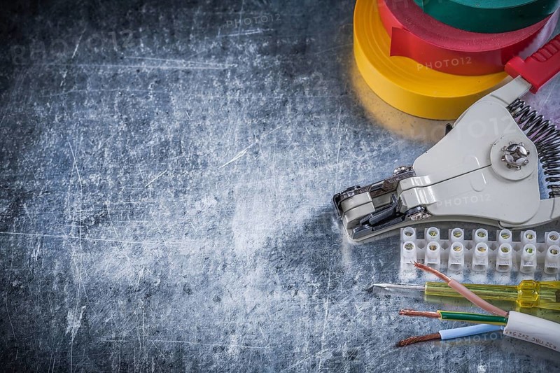 Electrician's set on scratched metallic background copy space electricity concept