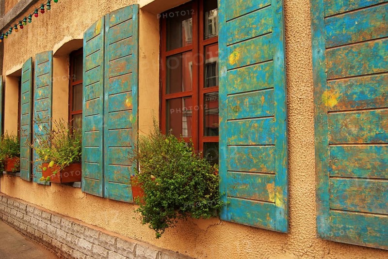 Windows of antique house decorated with flowers