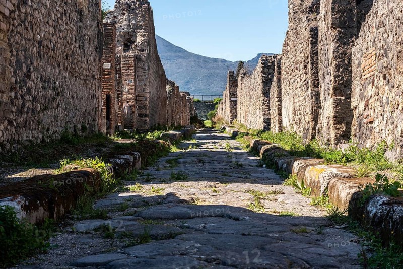 POMPEII, ITALY, MAY 04, 2022, A beautiful typical cobbled street in the ancient city of Pompeii, Southern Italy