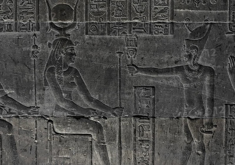 Hieroglyphic carvings on the wall of an ancient egyptian temple