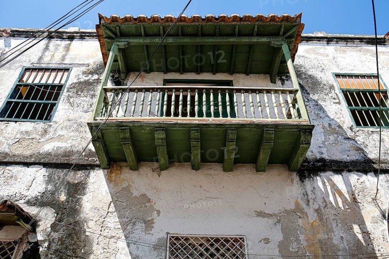 Low angle view of a green roofed balcony at an old house in Old Town Cartagena, Brazil, South America