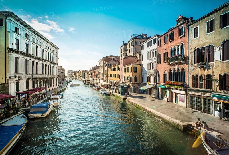 Ancient buildings and boats in the channel in Venice