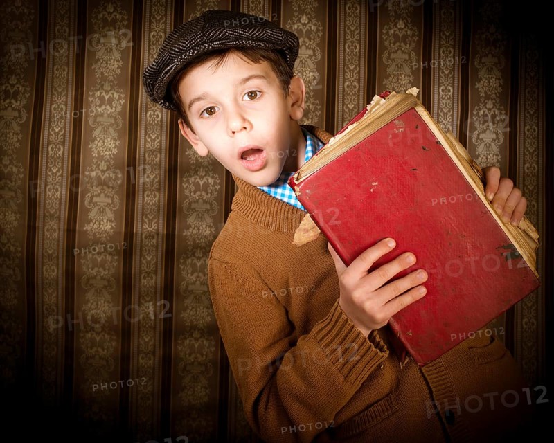 Child with red vintage book. Vintage clothes and hat