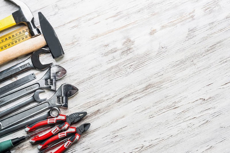 Variety of repair tools on wooden surface