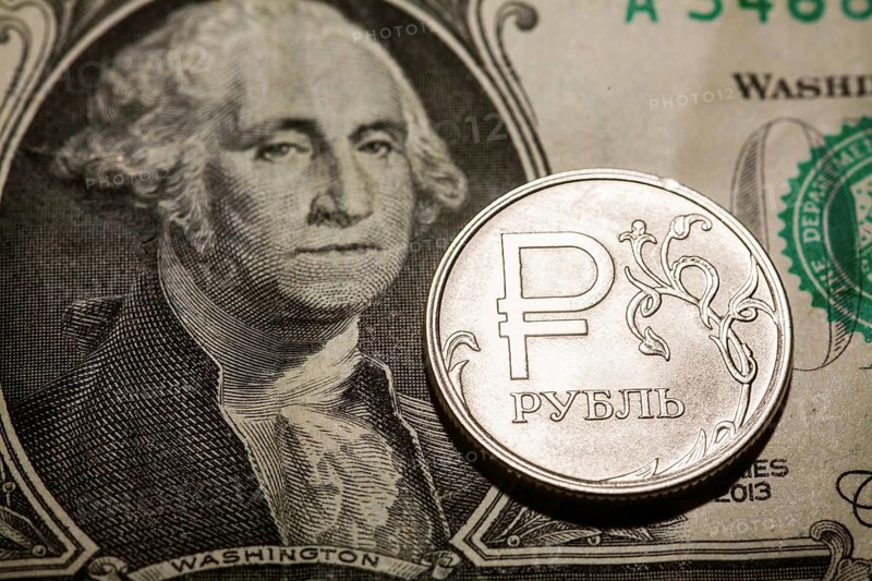 One ruble coin on dollar banknote. Closeup, macro shot