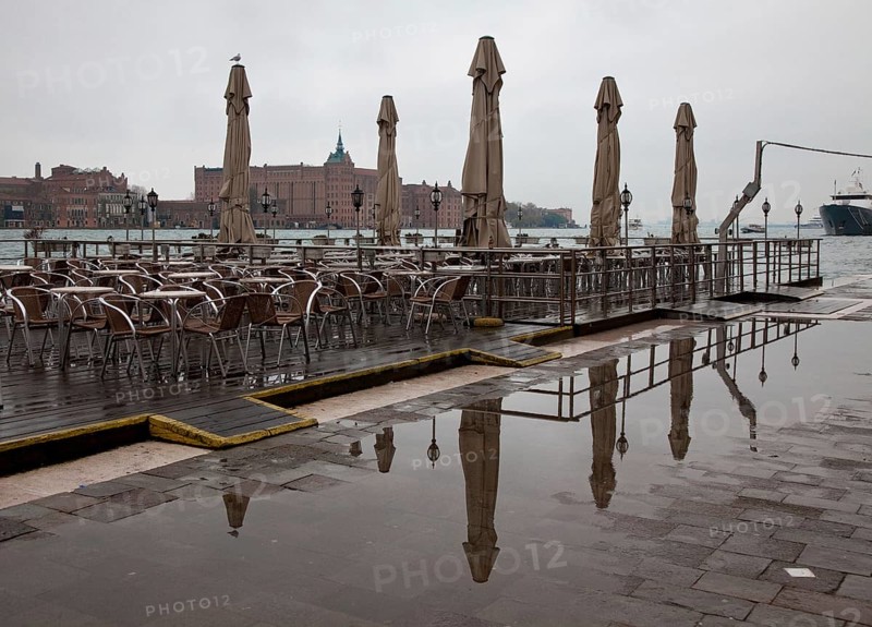 Italy Venice Zattere quay -145 Restaurant terrace on a pontoon on the Canale della Guidecca in November in the background the Stucky mill today hotel