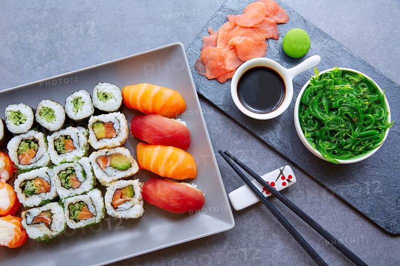 Sushi Maki and Niguiri California roll with seaweed chuka salad soy sauce and wasabi