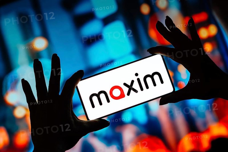 In this photo illustration, the Maxim logo is displayed on a smartphone screen