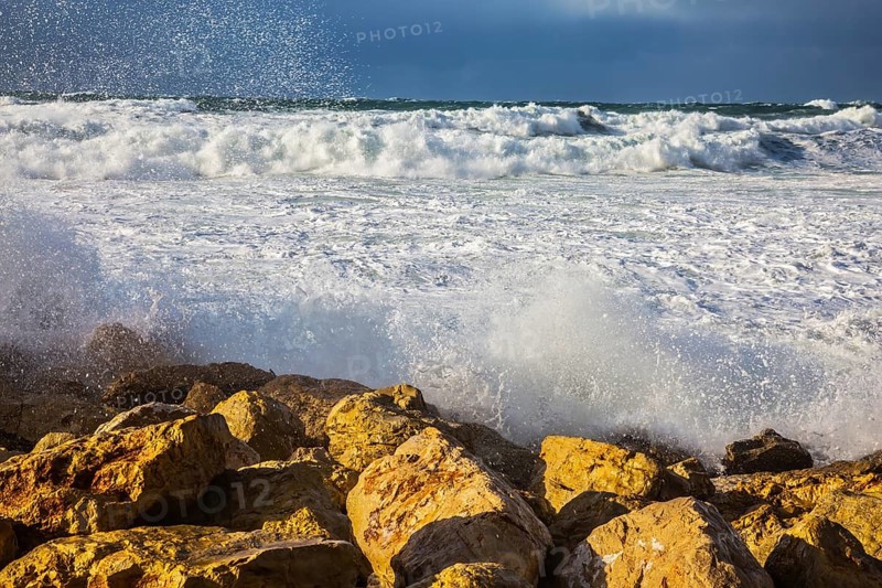 New Quay in the Old Jaffa in a winter storm. Huge foaming waves of the Mediterranean beat against the shore rocks. Tel Aviv in January