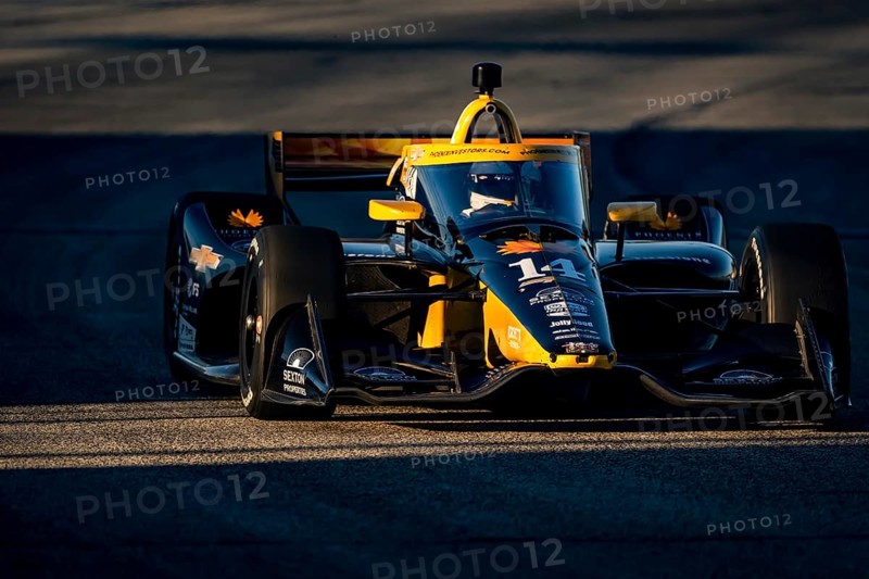 As the sun starts to set, NTT INDYCAR SERIES driver, SANTINO FERRUCCI (14) USA of Woodbury, Connecticut races through the turns during the Hy-Vee Milwaukee Mile 250's at The Milwaukee Mile in West Allis, WI, West Allis, United States of America