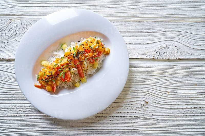 Seafood red curry with shrimps prawns sprouts and sesame seeds