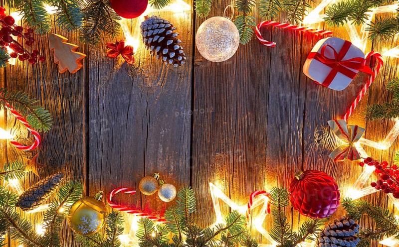 Christmas glowing stars and fir on vintage wooden background copy space