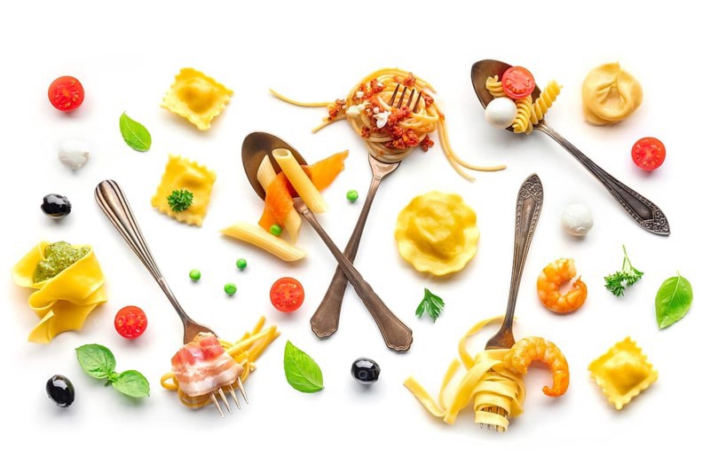 Various pasta forks. Spaghetti, fusilli, penne and other shapes of pasta, with sauce, overhead flat lay shot on a white background. Bolognese, Carbonara et al, Food photography, Food photography