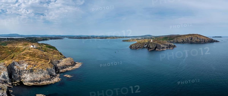 A panorama view of the entrance to the Baltimore Harbor in West Cork with teh Sherkin Island Lighthouse and the Baltimore Beacon