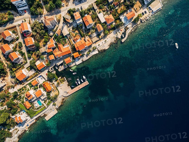 Aerial footage from the drone - villas, houses and hotels on the beach in Montenegro, the Adriatic Sea.